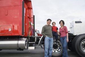 Family standing by their truck